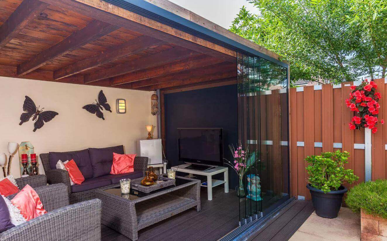 Fiano frameless sliding glass panels enclose this garden room